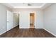 Bedroom featuring tray ceilings, wood floors, neutral walls, and two doorways at 18001 Richmond Place Dr # 1032, Tampa, FL 33647