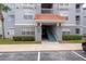 Close-up shot of a condo entrance with well-kept landscaping and clear unit number signage at 18001 Richmond Place Dr # 1032, Tampa, FL 33647