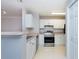 Efficient kitchen with white cabinets and stainless steel appliances at 18001 Richmond Place Dr # 1032, Tampa, FL 33647