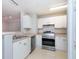Bright kitchen showcasing white cabinetry and stainless steel appliances at 18001 Richmond Place Dr # 1032, Tampa, FL 33647