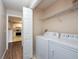 Laundry room with washer and dryer, shelf and access to the kitchen at 18001 Richmond Place Dr # 1032, Tampa, FL 33647