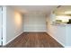 Bright living room with hardwood floors, a dining area and a bar overlooking the kitchen at 18001 Richmond Place Dr # 1032, Tampa, FL 33647
