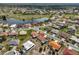 A bird's eye view reveals a serene neighborhood near the lake and golf course at 1803 Granville Ln, Sun City Center, FL 33573