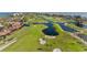 Aerial view showcasing a well-maintained golf course, waterfront views and lush landscaping at 2410 Harbourside Dr # 142, Longboat Key, FL 34228