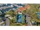 Stunning aerial view showcasing tennis courts, marina, and clubhouse, all surrounded by lush landscaping at 2410 Harbourside Dr # 142, Longboat Key, FL 34228