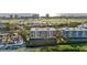 Aerial view showcasing a white mid-rise condominium building and golf course at 2410 Harbourside Dr # 142, Longboat Key, FL 34228