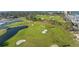 Aerial view of a well-manicured golf course with lush greens, sand traps, and scenic water features at 2410 Harbourside Dr # 142, Longboat Key, FL 34228