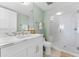 This renovated bathroom features a modern vanity with marble countertops and glass shower at 2410 Harbourside Dr # 142, Longboat Key, FL 34228