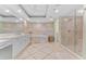 Elegant bathroom featuring a soaking tub, glass-enclosed shower, and dual vanities with marble countertops at 2410 Harbourside Dr # 142, Longboat Key, FL 34228