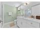 Bathroom with a white marble countertop, white cabinets, and silver hardware at 2410 Harbourside Dr # 142, Longboat Key, FL 34228