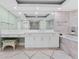 Bright bathroom showcasing a large mirror, white vanity, and patterned rug adding a touch of comfort at 2410 Harbourside Dr # 142, Longboat Key, FL 34228