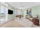 Bright bedroom features plantation shutters, a ceiling fan, and a comfortable seating area at 2410 Harbourside Dr # 142, Longboat Key, FL 34228