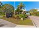 Community signage 'Marina Bay' amidst lush landscaping, enhancing curb appeal and property value at 2410 Harbourside Dr # 142, Longboat Key, FL 34228