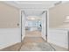 Inviting entryway with double doors leading to a spacious and well-lit interior featuring beautiful flooring at 2410 Harbourside Dr # 142, Longboat Key, FL 34228