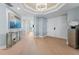 Charming foyer with a chandelier, wall art, and gleaming hardwood flooring create a welcoming ambiance at 2410 Harbourside Dr # 142, Longboat Key, FL 34228