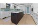 Well-appointed kitchen with white cabinetry, a center island, and modern stainless steel appliances at 2410 Harbourside Dr # 142, Longboat Key, FL 34228