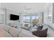 Cozy living room with a large sectional, a flat-screen TV, and access to a balcony with water views at 2410 Harbourside Dr # 142, Longboat Key, FL 34228