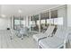 Enjoy outdoor living on this tiled patio with seating and lounge chairs overlooking stunning water views at 2410 Harbourside Dr # 142, Longboat Key, FL 34228