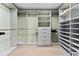 This walk-in closet has custom shelving, drawers, and plentiful storage space at 2410 Harbourside Dr # 142, Longboat Key, FL 34228