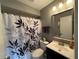 Neutral bathroom featuring a decorative shower curtain and modern fixtures at 2465 Northside Dr # 604, Clearwater, FL 33761