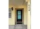 Inviting front door entrance with black-trimmed glass door, textured walls, and visible unit number at 2465 Northside Dr # 604, Clearwater, FL 33761