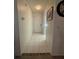Hallway featuring white tile floors with decorative trim and access to other areas of the home at 2465 Northside Dr # 604, Clearwater, FL 33761