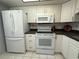 Well-maintained kitchen equipped with white appliances and ample cabinet space at 2465 Northside Dr # 604, Clearwater, FL 33761
