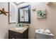 Bathroom featuring a granite vanity, neutral paint, and decorated with beach-themed ornaments at 2537 Royal Pines Cir # 19I, Clearwater, FL 33763