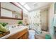 Bright bathroom with a skylight, a shower-tub combination, and a refreshing tropical theme at 2537 Royal Pines Cir # 19I, Clearwater, FL 33763