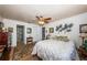 Bedroom features a ceiling fan, wood flooring, and access to a bathroom and closet at 2537 Royal Pines Cir # 19I, Clearwater, FL 33763