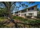 A two-story condo building with a well-maintained lawn and mature trees, offering a serene and inviting appeal at 2537 Royal Pines Cir # 19I, Clearwater, FL 33763