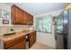Well-lit kitchen with tile backsplash, stainless steel appliances, and ample cabinet space at 2537 Royal Pines Cir # 19I, Clearwater, FL 33763