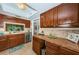 Kitchen view showcasing stainless steel appliances, warm wood cabinets, and a breakfast bar at 2537 Royal Pines Cir # 19I, Clearwater, FL 33763