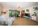 Inviting living room with tiled floor, tropical decor, slider to Florida room, and natural lighting at 2537 Royal Pines Cir # 19I, Clearwater, FL 33763