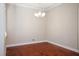 Empty dining room with hardwood floors, neutral walls, and a decorative chandelier at 2685 Waters Edge Ct, Dunedin, FL 34698