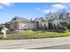 Charming single-story home featuring stone accents, shutters, and lush landscaping at 2685 Waters Edge Ct, Dunedin, FL 34698