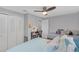 Bright bedroom featuring twin beds, a closet, desk area, and wood-look flooring at 27103 Frampton Ave Ave, Brooksville, FL 34602