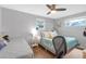 Bright bedroom featuring twin beds, a ceiling fan, desk area, and wood-look flooring at 27103 Frampton Ave Ave, Brooksville, FL 34602