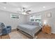 Bright bedroom featuring a ceiling fan, hardwood floors, and a cozy recliner at 27103 Frampton Ave Ave, Brooksville, FL 34602