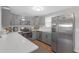 Gray kitchen featuring stainless steel appliances, including a microwave, oven, and refrigerator at 27103 Frampton Ave Ave, Brooksville, FL 34602