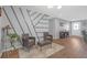 Stylish seating area with a gray accent wall, wood floors, and an open view of the entrance at 27103 Frampton Ave Ave, Brooksville, FL 34602