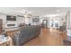 Open living area with wood floors, modern furniture, ceiling fan, fireplace, and stainless steel appliances at 27103 Frampton Ave Ave, Brooksville, FL 34602