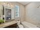 Well-lit bathroom with a tiled shower, a granite vanity, and tiled flooring at 28935 Lucero Ln, Wesley Chapel, FL 33543