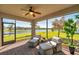 The screened patio boasts lovely water views, comfortable seating, and a ceiling fan at 28935 Lucero Ln, Wesley Chapel, FL 33543