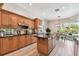 This spacious kitchen features wood cabinets, stainless appliances, and a center island at 2927 Northfield Dr, Tarpon Springs, FL 34688