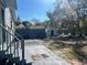 View of backyard with partial fence, shed, trees, patio and outdoor seating at 300 S Highland Ave, Tarpon Springs, FL 34689