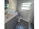 Stylish bathroom with elegant vanity, decorative flooring, and modern fixtures at 300 S Highland Ave, Tarpon Springs, FL 34689