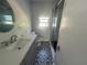 Modern bathroom with decorative flooring, and updated shower with natural light at 300 S Highland Ave, Tarpon Springs, FL 34689