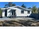 A charming single-story home featuring a textured exterior and a well-maintained yard at 300 S Highland Ave, Tarpon Springs, FL 34689