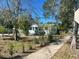 Charming single-story home with landscaping along a paved walkway at 300 S Highland Ave, Tarpon Springs, FL 34689